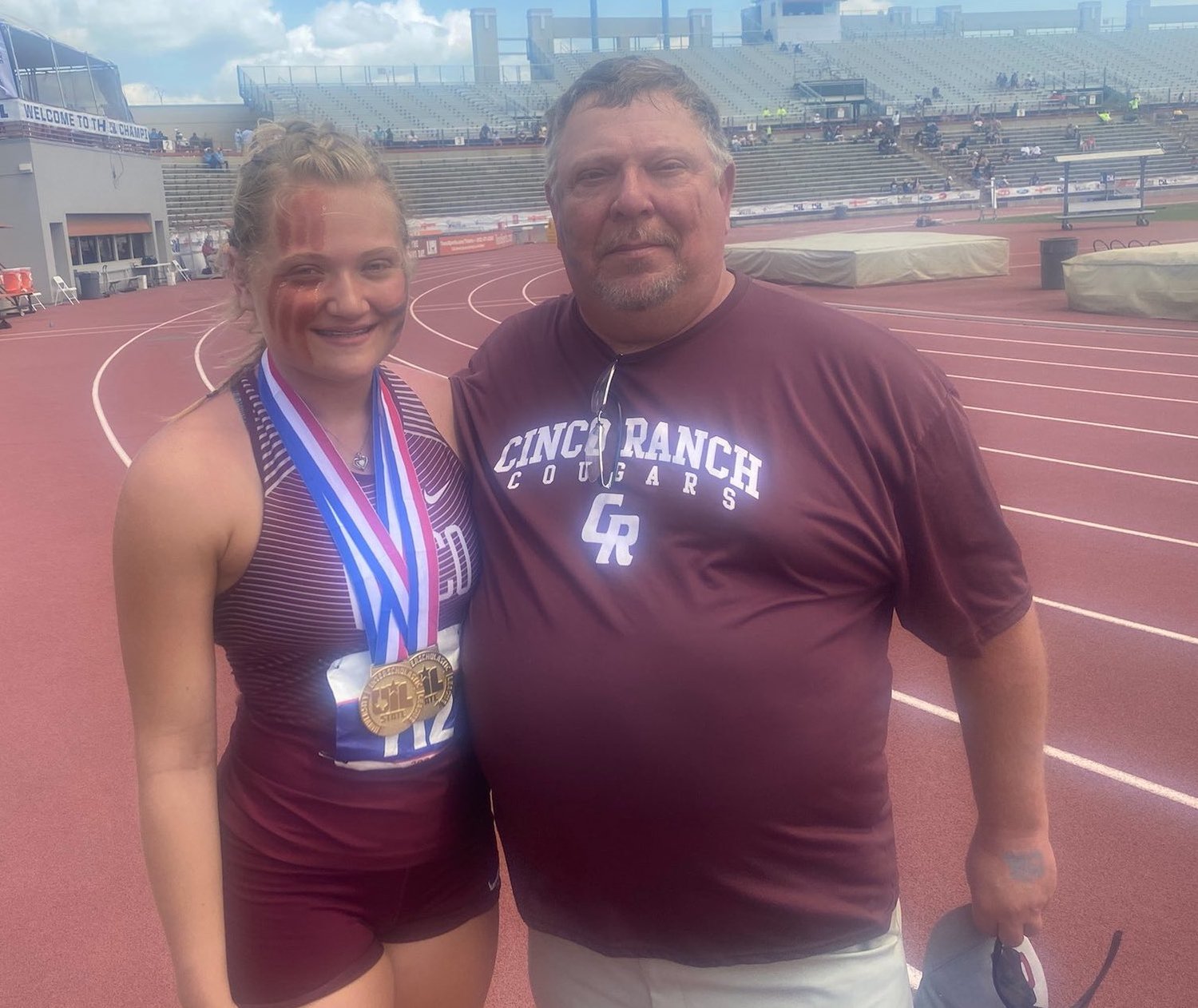 Cinco Ranch senior thrower Amelia Flynt is pictured with Cinco Ranch throws coach J.D. Fincher after winning gold in the discus and shot put throws at the Class 6A state track and field meet Saturday, May 8, at Mike A. Myers Stadium at the University of Texas at Austin. Fincher is retiring after 30 years of coaching.
